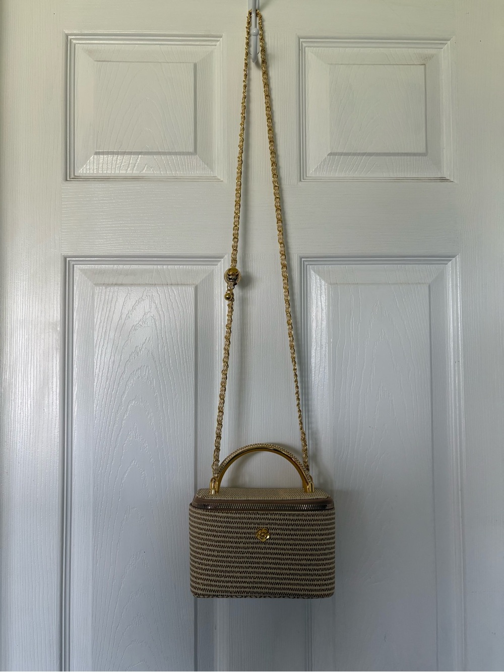 Tan purse with gold detail and adjustable strap